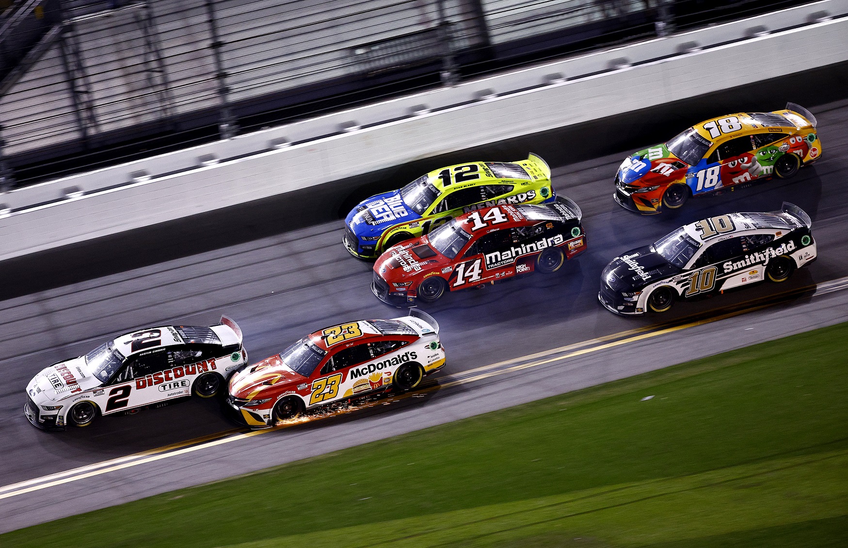 DAYTONA BEACH, FLORIDA - FEBRUARY 20: Austin Cindric, driver of the #2 Discount Tire Ford, and Bubba Wallace, driver of the #23 McDonald's Toyota, race to the finish of the NASCAR Cup Series 64th Annual Daytona 500 at Daytona International Speedway on February 20, 2022 in Daytona Beach, Florida