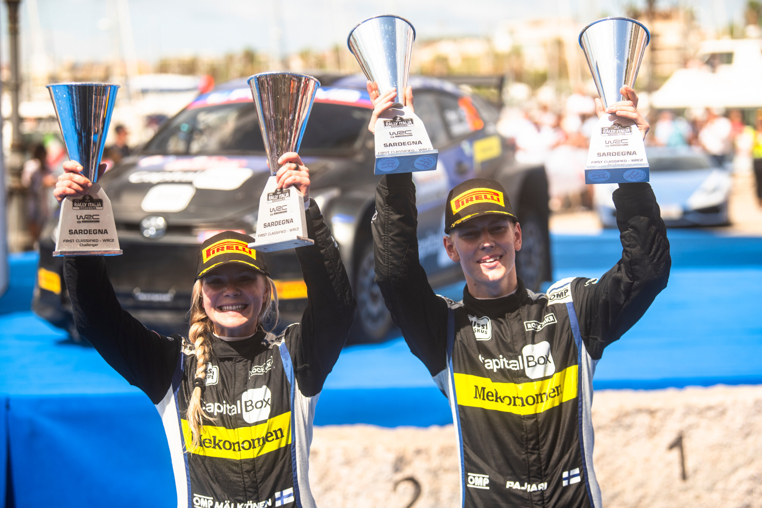 Sami Pajari (FIN) and Enni Mälkönen (FIN) celebrate on the podium in first place after winning the World Rally Championship WRC 2 class in Alghero, Italy on 02.06.2024 //