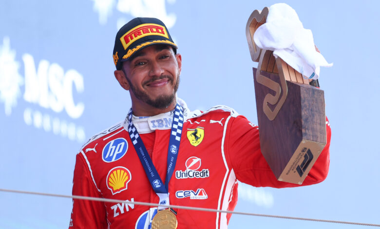 BARCELONA, SPAIN - JUNE 14: Race winner Lewis Hamilton of Great Britain and Scuderia Ferrari celebrates with his trophy on the podium during the F1 Grand Prix of Barcelona-Catalunya at Circuit de Barcelona-Catalunya on June 14, 2026 in Barcelona, Spain. (Photo by