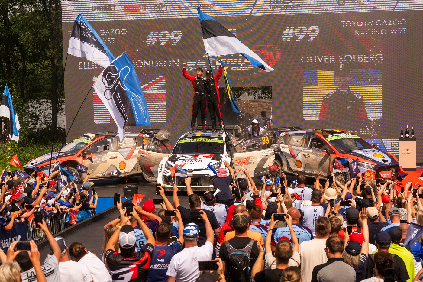 Oliver Solberg of Sweden and Elliott Edmondson of United Kingdom, with Ott Tänak of Estonia and Martin Järveoja of Estonia and of Hyundai Shell Mobis World Rally Team in second place, Thierry Neuville of Belgium and Martijn Wydaeghe of Belgium and Hyundai Shell Mobis World Rally Team in third place, celebrate their win at the World Rally Championship in Tartu, Estonia on July 20, 2025 //